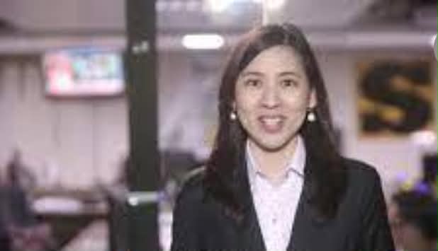 Woman presenting in a newsroom