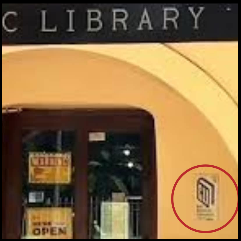 Library entrance with a plaque circled in red